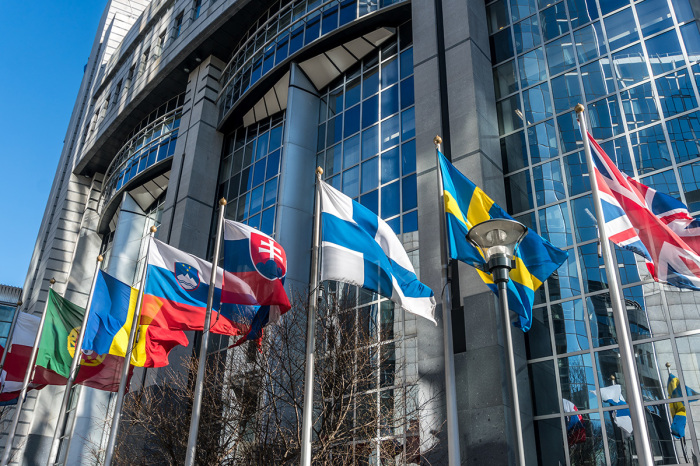 European national flags in front of European Parliament building in Brussels, Belgium.