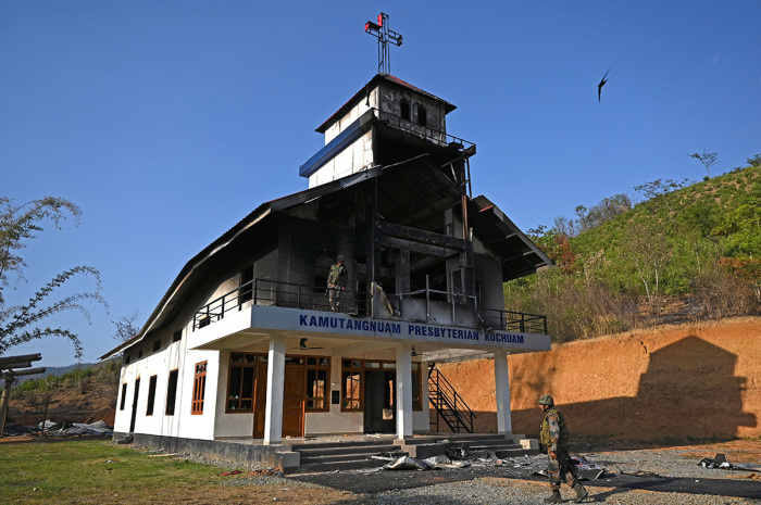 Indian army soldiers inspect the debris of a ransacked church that was set on fire by a mob in the ethnic violence hit area of Heiroklian village in Senapati district, in India's Manipur state on May 8, 2023. - Around 23,000 people have fled the unrest which erupted last week in the hilly northeast state bordering Myanmar. The latest clashes erupted between the majority Meitei people, who are mostly Hindu, living in and around the Manipur capital Imphal and the mainly Christian Kuki tribe of the hills. 