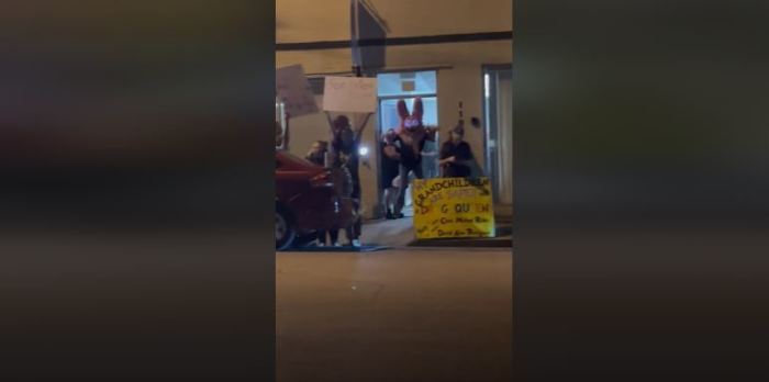 A screenshot of a video from outside a drag show at a North Texas church as a person in a 'furry' costume stands in the doorway.