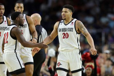 Matt Bradley #20 of the San Diego State Aztecs celebrates with Darrion Trammell #12 during the second half against the Florida Atlantic Owls during the NCAA Men's Basketball Tournament Final Four semifinal game at NRG Stadium on April 01, 2023 in Houston, Texas. 