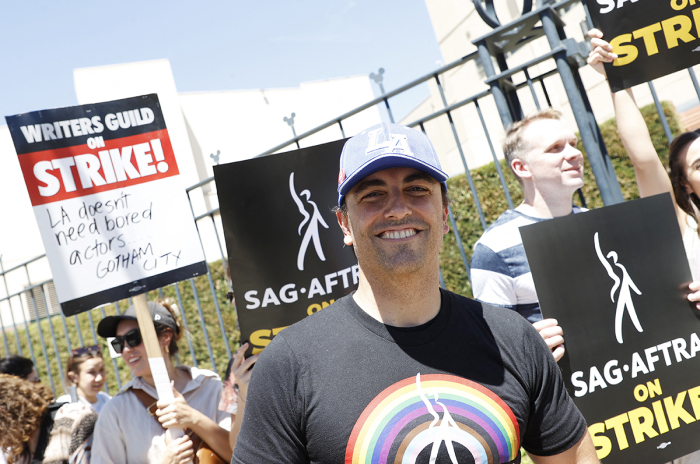 Mayor of Burbank, Konstantine Anthony, walks a picket line alongside members of the Writers Guild of America and the Screen Actors Guild outside Disney Studios in Burbank, California, on July 14, 2023. Tens of thousands of Hollywood actors went on strike at midnight July 13, 2023, effectively bringing the giant movie and television business to a halt as they join writers in the first industry-wide walkout for 63 years. 