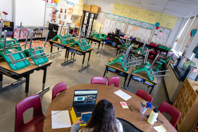 A teacher interacts with students virtually while sitting in an empty classroom during a period of Non-Traditional Instruction (NTI) at Hazelwood Elementary School on January 11, 2022, in Louisville, Kentucky. Jefferson County Public Schools, along with many other school districts in the US, have switched to NTI in response to severe staffing shortages caused by the prevalence of the omicron variant of COVID-19. 