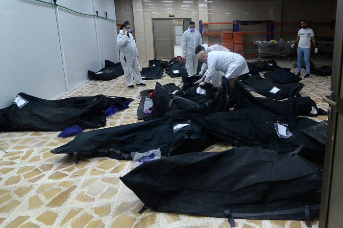 Bodies of people killed in a fire during a wedding in an event hall in Qaraqosh, also known as Hamdaniyah, are piled up at the morgue of a hospital in Mosul on September 27, 2023. At least 100 people were killed and more than 150 injured when the fire broke out. 