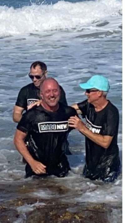 Danny De Armas (R), senior associate pastor at First Baptist Orlando baptizes Joe Mills (L). Behind Mills is Chris Bacon, a youth minister at First Baptist Orlando.