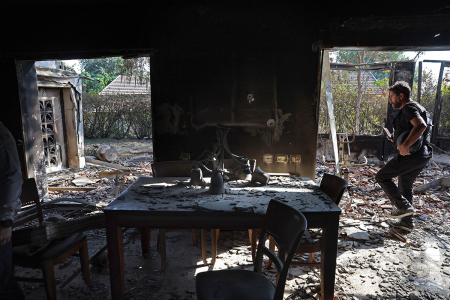 A man checks the interior of a house damaged in the October 7 attack by Palestinian Hamas terrorists on kibbutz Beeri near the border with Gaza, on October 14, 2023. Thousands of people, both Israeli and Palestinians have died since October 7, 2023, after Hamas militants massacred Israeli civilians in a surprise attack leading Israel to declare war on Hamas in the Gaza Strip enclave on October 8.