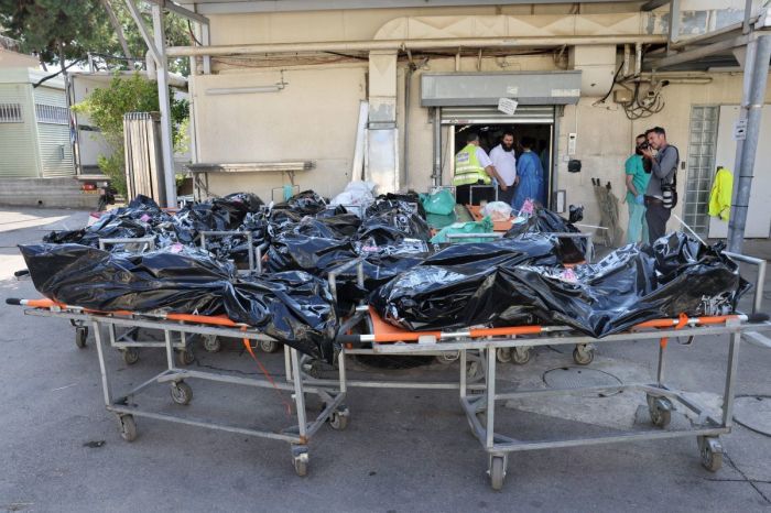 Bodies of people killed in the attack by Gaza-based Hamas militants on southern Israel await identification outside the National Center for Forensic Medicine in Tel Aviv on October 16, 2023. 