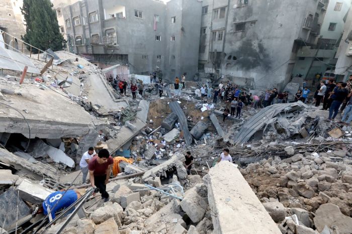 Palestinians search the destroyed annex of the Greek Orthodox Saint Porphyrius Church, the oldest church still in use in Gaza, damaged in a strike on Gaza City on October 20, 2023, amid the ongoing battles between Israel and the Palestinian group Hamas. 