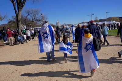 Demonstrators at the March for Israel rally in Washington, D.C. are wrapped in Israeli flags on Nov. 14, 2023.