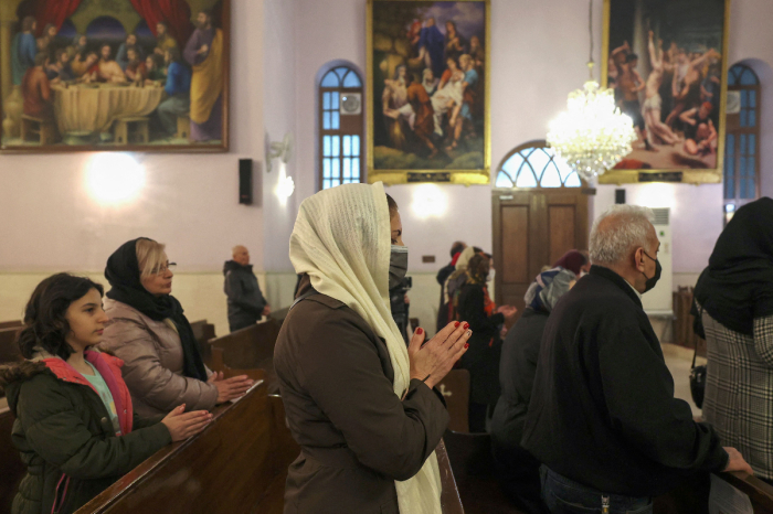 Iranian Christians attend the New Year mass at the Saint Targmanchats Armenian Church in Tehran, early on January 1, 2023. 