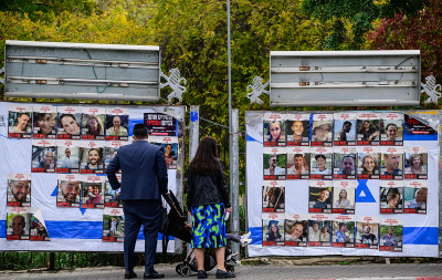 A couple with children looks at portraits of Israeli hostages held in Gaza since the October 7 attacks by Hamas terrorists, on billboards in Jerusalem as a truce between Israel and Hamas entered its second day on November 25, 2023. Hamas is expected to release another 14 Israeli hostages in exchange for 42 Palestinian prisoners on November 25, as part of a four-day truce in their seven-week war. 