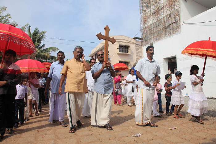 Unidentified devotees hold the holy cross on their head during the annual celebration of the Malankara Orthodox Church on Nov. 2, 2010, in Parumala, Kerala, India.