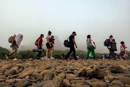 Migrants walk by the jungle near Bajo Chiquito village, the first border control of the Darien Province in Panama, on September 22, 2023. The clandestine journey through the Darien Gap usually lasts five or six days, at the mercy of all kinds of bad weather and cartels involved in human trafficking and drug smuggling . 