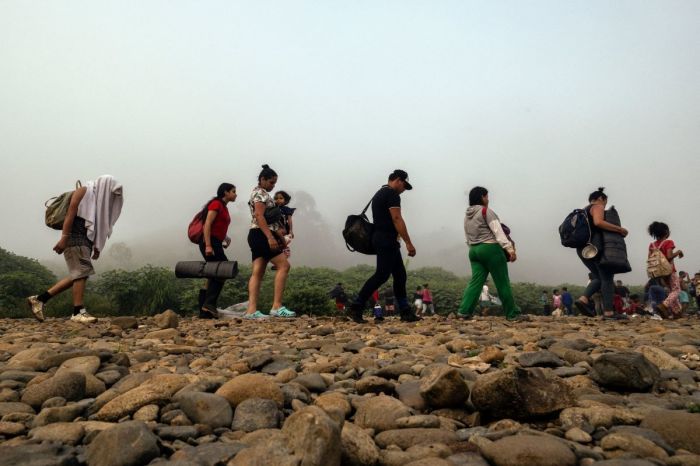 The migrants walk near the jungle near the village of Bajo Chiquito, the first border control of the Darien province of Panama, on September 22, 2023. The clandestine journey through Gapul Darien usually lasts five or six days, at the mercy of all kinds of bad weather and cartels involved in human trafficking and smuggling drugs. 