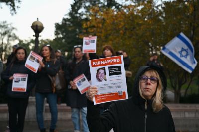 A woman holds a poster of Israeli hostage Omer Neutra during a memorial vigil for the Israeli people killed by Hamas during the October 7 attacks, in New York City on November 1, 2023. 