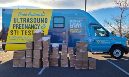 The 100th Save the Storks mobile medical center, which was dedicated in December 2023. Supplies of EveryLife diapers are in the foreground.