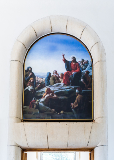 A drawing on the wall with a plot, as Jesus preaches to people over the exit to the Beatitude Monastery located on the mountain on the coast of the Sea of Galilee.