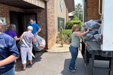 Volunteers with The Tide Ministry pack up shoe donations during their charity event 'Your Soles, Their Souls.' 