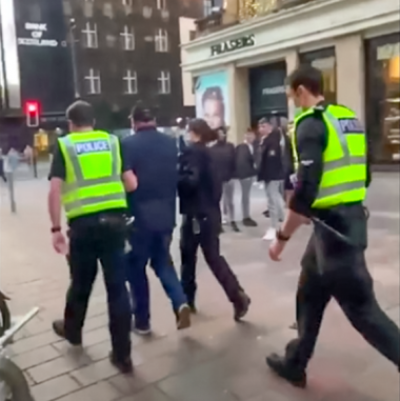 Angus Cameron being led away by police in Glasgow city centre. 