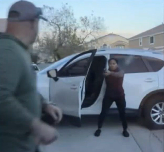 The moment Joe Junio (holding a gun), 36, fatally shot 46-year-old Nicholas Davi (L) and his wife, Sarah Davi, on December 29, 2023, in a condominium complex near Deer Springs and Aviary ways in North Las Vegas, Nevada. 