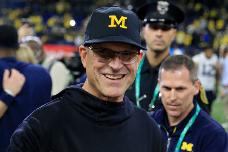 Head coach Jim Harbaugh of the Michigan Wolverines walks on the field after winning the Big Ten Football Championship game against the the Iowa Hawkeyes at Lucas Oil Stadium on December 04, 2021, in Indianapolis, Indiana. 