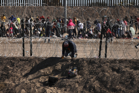 An illegal migrant man crosses through the banks of the Rio Grande to be processed by the Border Patrol El Paso Sector, Texas, after crossing from Ciudad Juarez, Mexico, on May 10, 2023. 