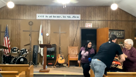 Pastor Brandon Stewart, founder of New Hope Fellowship Full Gospel Ministries, administers the Heimlich maneuver to save a congregant at Mount Zion Church in Gordon, Alabama, on February 15, 2024.