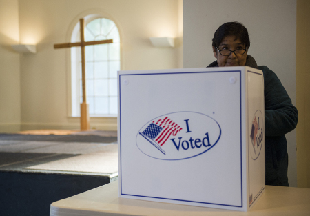 A woman cast her ballot at a church polling station in Fairfax, Virginia, during the U.S. presidential election on November 8, 2016. 