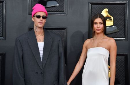 Canadian singer-songwriter Justin Bieber (L) and U.S. model Hailey Bieber arrive for the 64th Annual Grammy Awards at the MGM Grand Garden Arena in Las Vegas on April 3, 2022. 