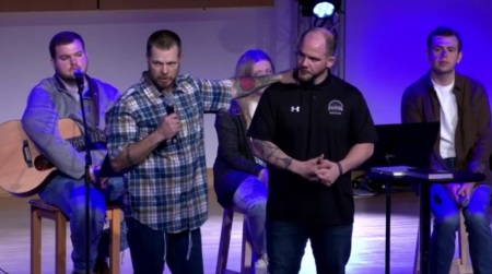 Joe Kilman (L) speaks during a chapel event at Campbellsville University in Kentucky on Feb. 28, 2024. Standing to his left is university admissions counselor Travis McIntosh.