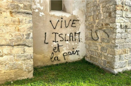 Defaced Catholic church building in Lieusaint, France. 