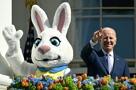 U.S. President Joe Biden, alongside the Easter Bunny (L), gestures after speaking at the annual Easter Egg Roll on the South Lawn of the White House in Washington, D.C., on April 10, 2023.