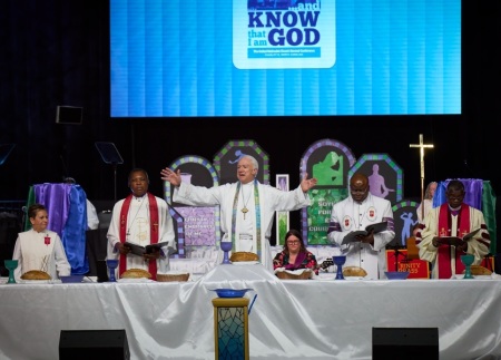 During the opening worship service of the United Methodist General Conference in Charlotte, North Carolina, on April 23, 2024, five United Methodist bishops from around the world celebrate communion with participants.