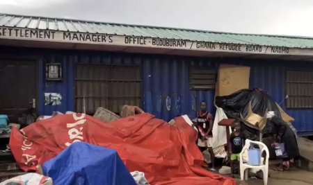 Displaced people whose homes were demolished gather their belongings near the settlement manager's office of the Ghana Refugee Board. 