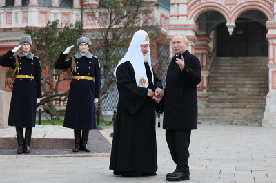 This pool photograph distributed by Russian state-owned agency Sputnik shows Russia's President Vladimir Putin and Russian Orthodox Patriarch Kirill (L) talking during a wreath-laying ceremony at the Monument to Minin and Pozharsky on Red Square on the National Unity Day in Moscow on November 4, 2023. 