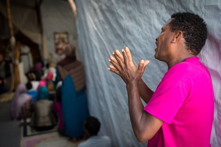 A man sings during an Orthodox service for Ethiopian and Eritrean worshippers at a church in a make shift camp near the port of Calais on August 2, 2015 in Calais, France. Hundreds of migrants are continuing to attempt to enter the Channel Tunnel and onto trains heading to the United Kingdom.