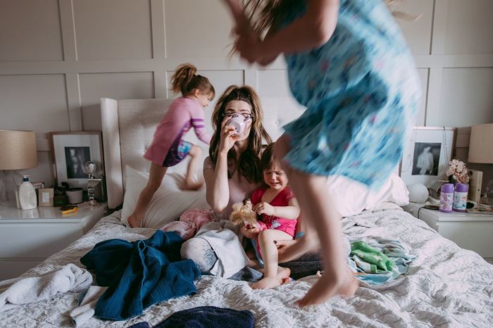 While her three daughters were jumping around her, she felt the stress of a young mother drinking a cup of coffee on her scattered bed. 