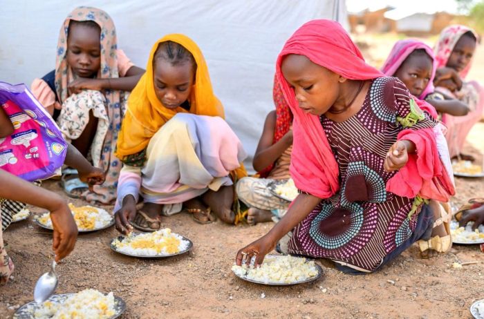 Children in Sudan eating food provided by World Vision.