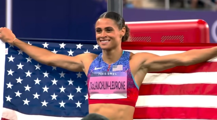 Sydney McLaughlin-Levrone holds the United States flag after securing her second gold medal in the women's 400-meter hurdles at the 2024 Summer Olympis in Paris, France, on Aug. 8, 2024. 