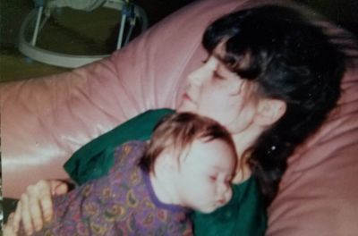 Erin Brewer, a woman who, as a child, self-identified as trans, is seen holding one of her three children after she overcame gender dysphoria. 