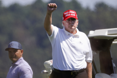 Former U.S. President Donald Trump gestures while golfing at Trump National Golf Club Sept. 13, 2022, in Sterling, Virginia.