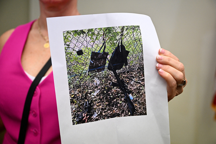 Press Information Officer Teri Barbera shows pictures of evidence found at the fence of former U.S. President Donald Trump's golf course at a press conference in West Palm Beach, Florida, on Sept. 15, 2024, following a shooting incident at Trump's golf course. Trump's campaign reported Sunday that there had been 'gunshots in his vicinity' but added that the Republican presidential candidate was safe.