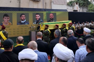 Hezbollah fighters carry the coffins of a person killed after hundreds of paging devices exploded in a deadly wave across Lebanon the previous day, during their funeral procession in Beirut's southern suburbs on September 18, 2024. Hundreds of pagers used by Hezbollah members exploded across Lebanon on September 17, killing at least nine people and wounding around 2,800 in blasts the Iran-backed militant group blamed on Israel. 