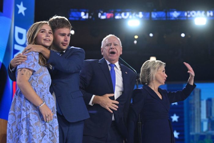 Minnesota Governor and 2024 Democratic vice presidential candidate Tim Walz (2nd R) stands with (from R) wife Gwen, and children Gus and Hope after speaking on the third day of the Democratic National Convention (DNC) at the United Center in Chicago, Illinois, on August 21, 2024. 