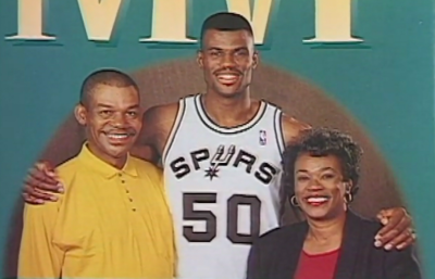 San Antonio Spurs Hall of Famer David Robinson (C) and his father, Ambrose Robinson (L) and mother, Freda Robinson (R) appear on this partial screenshot of the cover of the 1996 book written by his parents, 'How to Raise An MVP.' 