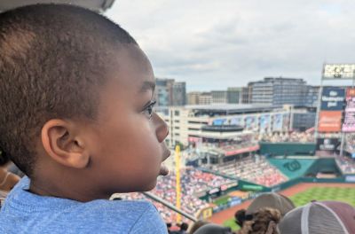 Kristian Alston enjoying his first baseball game during a McLean Faith Family Day. 