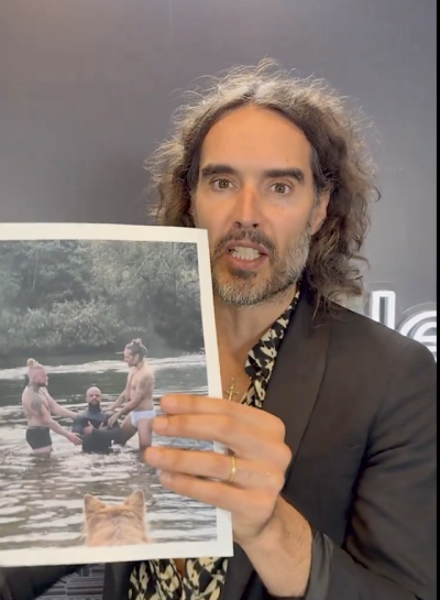 Russell Brand defends himself after posting a photo of himself performing a baptism wearing only underpants.