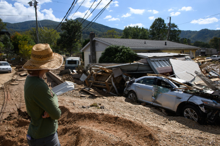 Emily Ogburn looks at her partner's home after it was destroyed by flooding on Oct. 2, 2024, in Swannanoa, North Carolina. According to reports, at least 160 people have been killed across the southeastern U.S., and more than a million are still without power due to the storm. The White House has approved disaster declarations in multiple southern states, freeing up federal emergency management money and resources. 