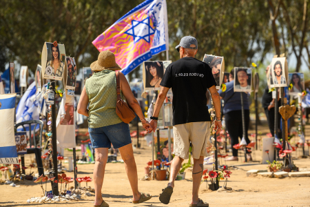 A man wearing a shirt that reads,'we wont forger 7.10.23' holds a woman's hand while visiting the Nova festival memorial site on Oct. 04, 2024, in Re'im, Israel. Over the last few months the grounds around Re'im Park have been turned into a memorial for the victims, and hostages from the Nova music festival which was attacked by Hamas on the morning of Oct. 7th. The site has been expanded to include stories of the victims, including first responders, police, and military, with other large personalized memorials. On Oct. 7, 2023, members of Hamas mounted a series of attacks and raids on Israeli citizens in the Gaza Envelope border area of Israel. Some 251 Israelis and foreigners were kidnapped with nearly 100 still unaccounted for and 1,139 people were killed.