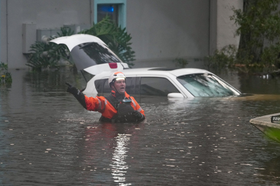 First responders in the water outside an apartment complex that was flooded from and overflowing creek due to Hurricane Milton on Oct. 10, 2024, in Clearwater, Florida. At least 16 people were confirmed killed as a result of two tornadoes triggered by Hurricane Milton on the east coast of the US state of Florida, local authorities said Thursday.