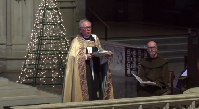 Bishop Marc Andrus (left), head of the Episcopal Diocese of California, speaking at a Christmas Eve service in 2023 at Grace Cathedral of San Francisco, California. 